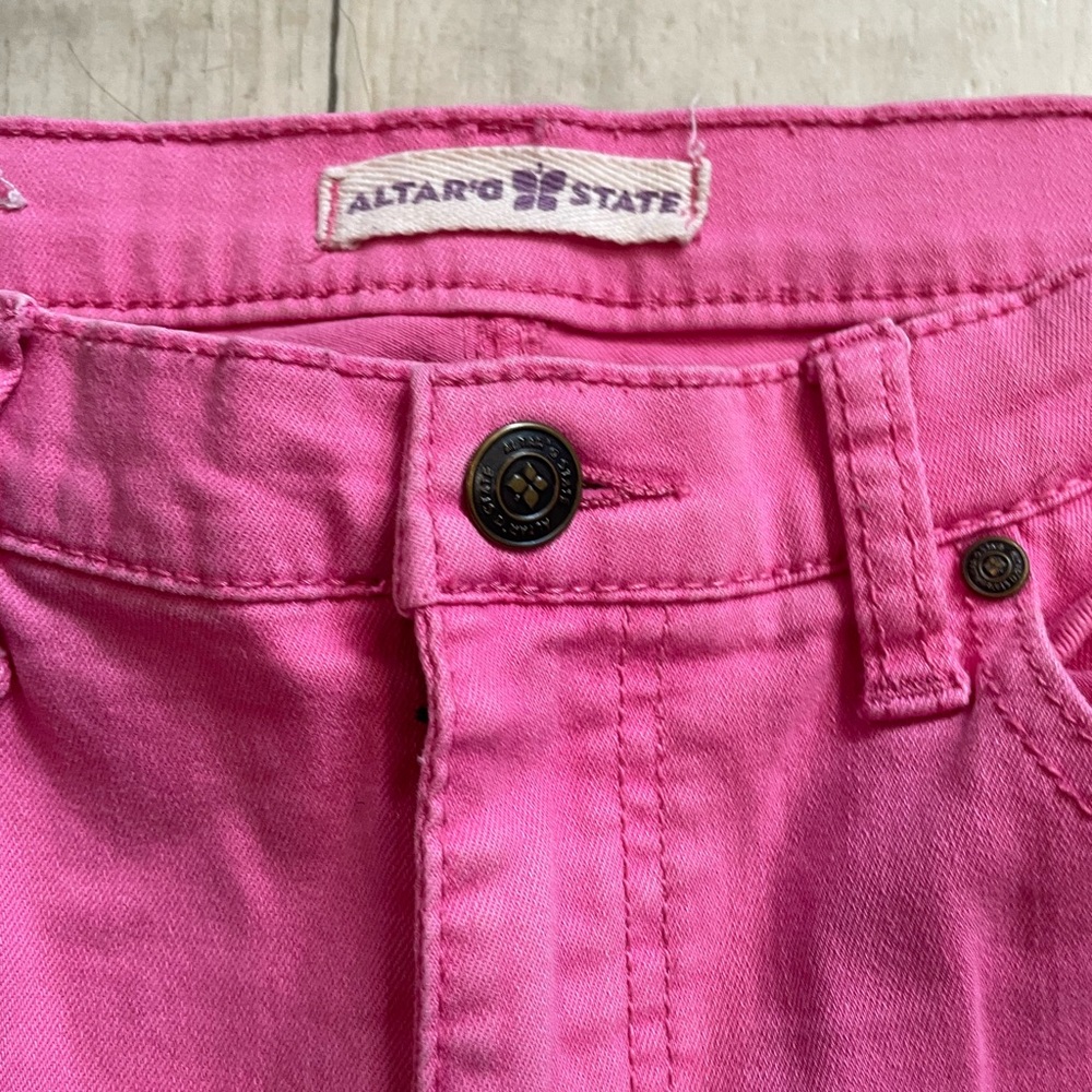 Altar’d State women’s pink skinny jeans.